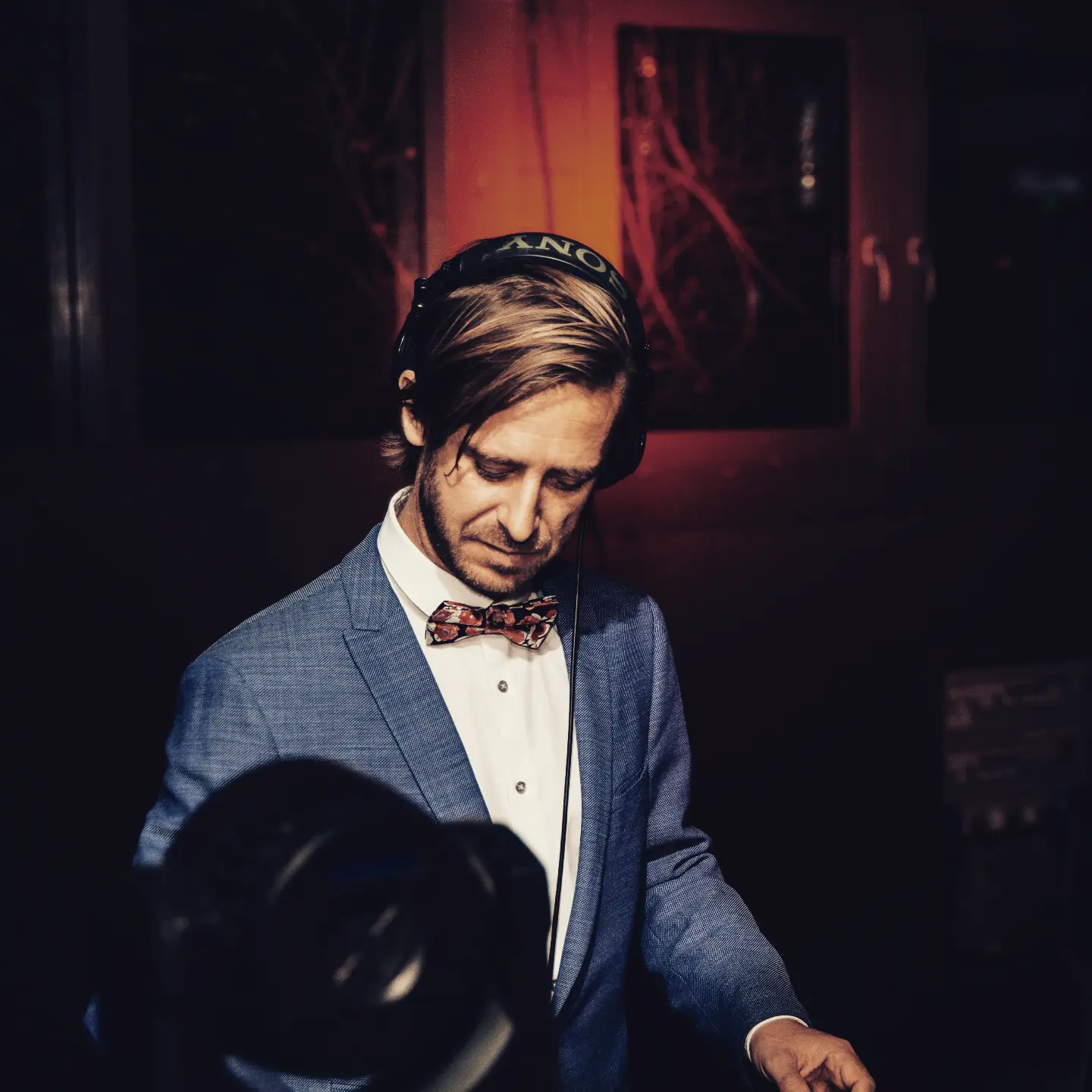DJ Chris Moro behind the decks at a refined event